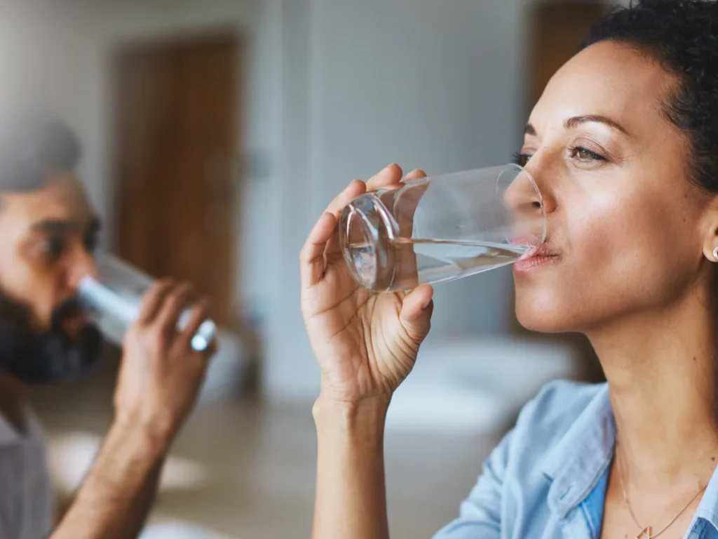 people drinking water from glass